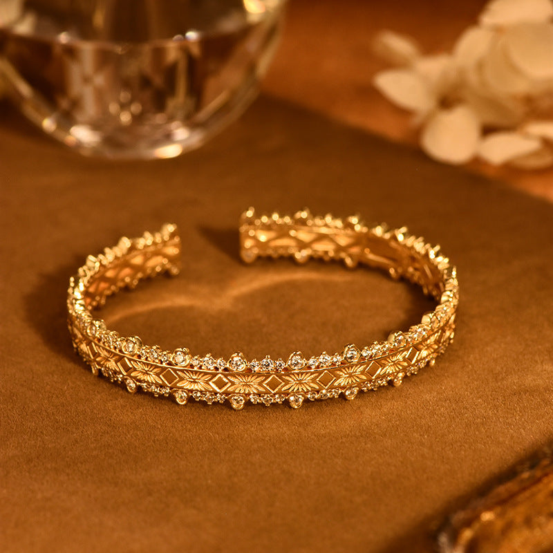 18K gold-plated bracelet features layered filigree craftsmanship